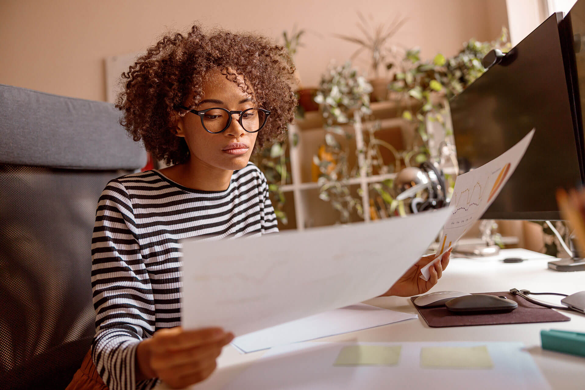 afro american woman studying documents at home